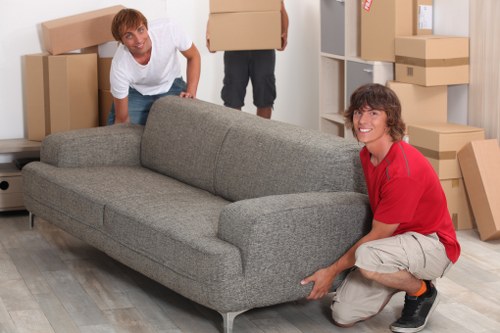 Professional movers transporting household items during a Chiswick relocation